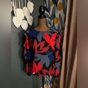 Cute work or party top! No wrinkle/perfect for travel. Ruffle detail on sleeve.